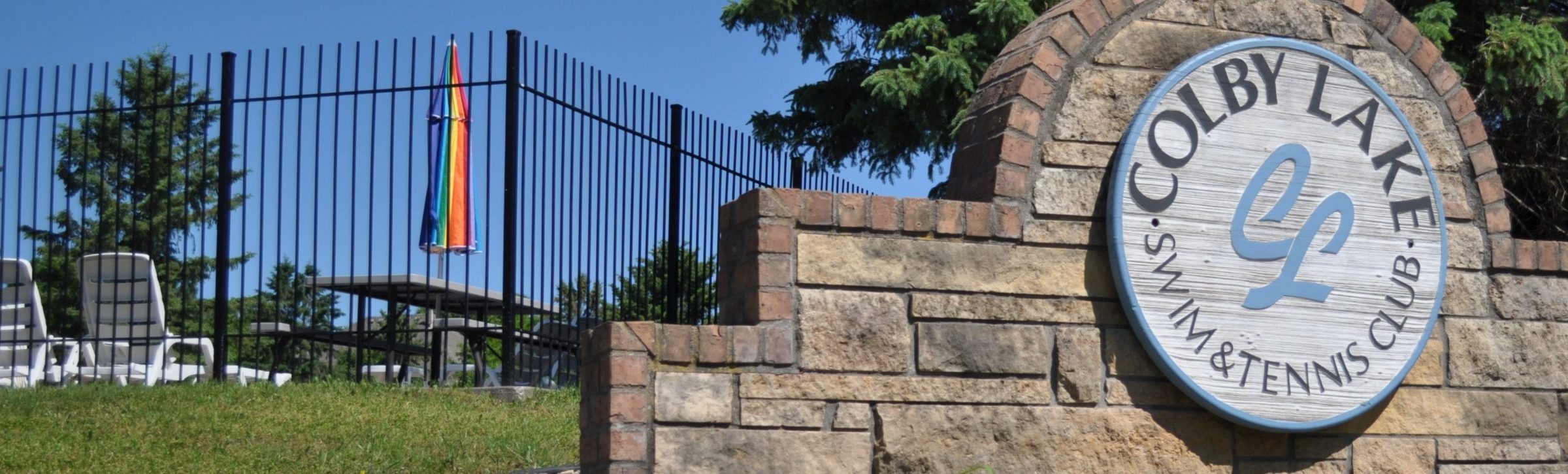 Colby Lake Swim and Tennis Club sign and pool